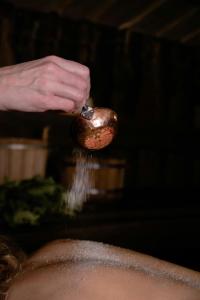 a person is sprinkling food on a spoon at WooLiv in Coimbatore