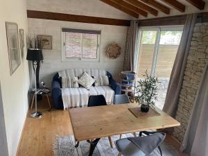 a living room with a table and a couch at La Chambre Haute, spa et jardin extérieur à Nîmes in Nîmes