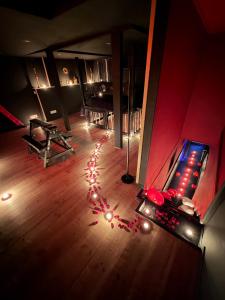 a room with a bowling alley with lights on the floor at L Antre du Désir in Saint-Léonard