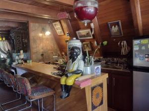 a statue of a woman sitting on a counter in a kitchen at cabaña master familiar in San Antonio de Pereira