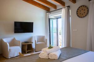 a bedroom with a bed and two chairs and a television at Agroturisme Vistalegre Nou in Manacor +29 photos