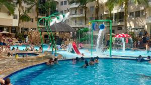 a group of people playing in a swimming pool at AP532 Thermas Paradise Cobertura Duplex 2 quartos in Rio Quente