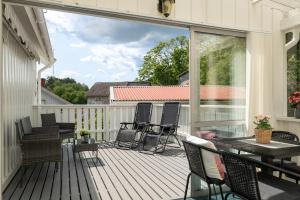 a screened in porch with a table and chairs on it at Linneby in Uddevalla +15 photos