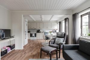 a living room with a couch and a kitchen at Linneby in Uddevalla