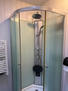 a shower with a glass door in a bathroom at Charmante maison vue chenal in Les Sables-d'Olonne +12 photos