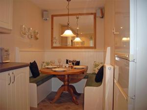 a small kitchen with a wooden table in a kitchen at 2 Bed in Birnam Dunkeld oc-ca266 in Birnam