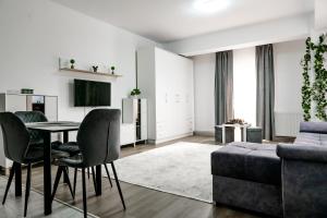 a living room with a table and a couch at New Airport Apartment in Sibiu