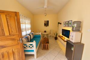 a living room with a couch and a television at Orange apartment 1 in Watamu