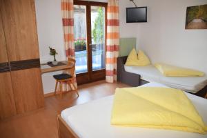 a hotel room with two beds and a window at Eichmannhof in Marlengo