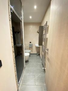a bathroom with a toilet and a sink at Residenza Basilica in Tirano +13 photos