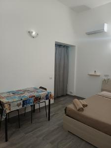 a room with two beds and a table in it at Casa vacanza Monoboito in Quartu SantʼElena +34 photos