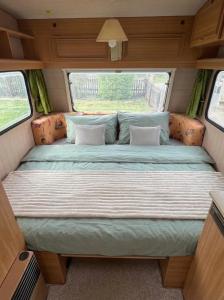 a bed in the back of a camper van at Camping im Lammgarten in Volkach +2 photos