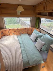 a large bed in the back of a rv at Camping im Lammgarten in Volkach