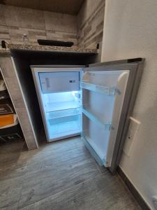 an empty refrigerator with its door open in a kitchen at Casa vacanza Monoboito in Quartu SantʼElena