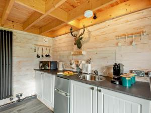 a kitchen with wooden walls and a counter with a sink at 1 Bed in Maryport oc-96373 in Dearham +6 photos