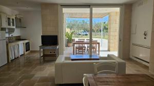 a living room with a couch and a table with chairs at Antica dimora "Nicole e Cristiano" in Otranto