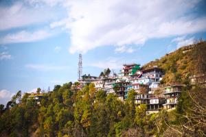 a building on the side of a hill at Bell Mount Mussoorie Hill view Hotel in Mussoorie +15 photos