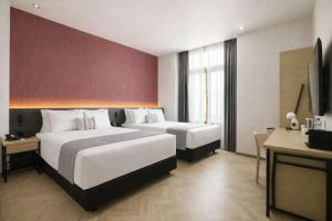 a hotel room with two beds and a television at Hotel Catedral in Mexico City +168 photos