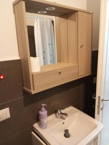 a bathroom with a sink and a mirror at Palazzo Lembo in Agnone +42 photos