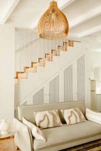 a living room with a couch and a staircase at Casa do Mar - Casas do Levante in Olhão