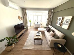 a living room with a couch and a table at Estoril by the Sea in Estoril