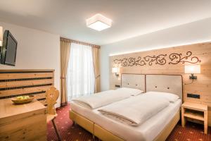 Säng eller sängar i ett rum på Hotel Maria
