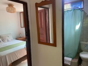 a bathroom with a bed and a mirror and a toilet at El Barquero in Puerto Baquerizo Moreno +26 photos