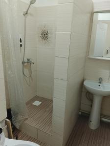 a bathroom with a shower and a sink at Atom hostel for men in Astana