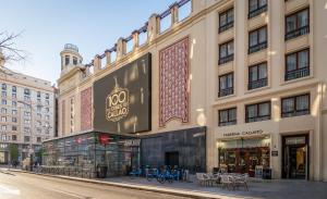 a large building with a store on a street at BYPILLOW Callao in Madrid