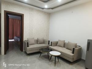 a living room with two couches and a table at THE BBN Hotel in Solan