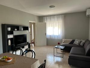 a living room with a couch and a table at Kuća za odmor - Snowwhite in Smoković +16 photos