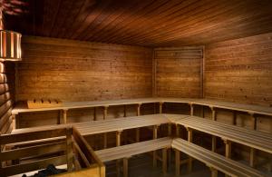 an empty sauna with wooden benches and a lamp at Leonardo Hotel Weimar in Weimar