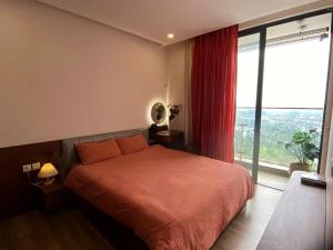 a bedroom with a bed and a large window at Caracole homestay - 2BR with cozy balcony garden in Kim Quan