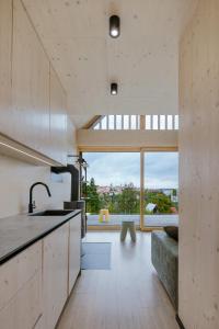 a kitchen with a view of a living room at Kabiny Kravák in Znojmo