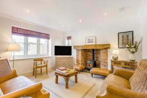 a living room with a couch and a fireplace at 5 Bed in Walberswick oc-hlwal in Walberswick