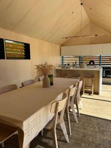 a large dining room with a table and chairs at Amurg Glamping&Pool in Vadu