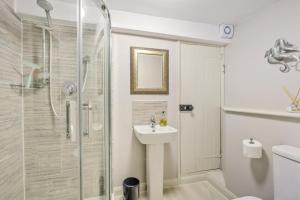 a bathroom with a shower and a sink and a toilet at 3 Bed in Dunwich oc-slh in Dunwich +21 photos