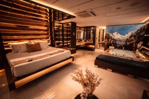 a bedroom with a large bed and a tub at 1Million Suites in Medellín