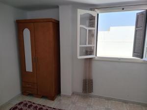 a room with a cabinet and a window at Studio ANDALOUS in Mahdia