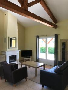 a living room with a couch and a coffee table at French country home II in Les Forges