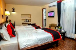 Postel nebo postele na pokoji v ubytování Taleju Boutique Hotel