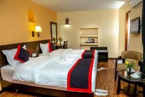 Postel nebo postele na pokoji v ubytování Taleju Boutique Hotel