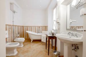 a bathroom with a tub and a toilet and a sink at Le Camere Del Ceccottino in Pitigliano +57 photos