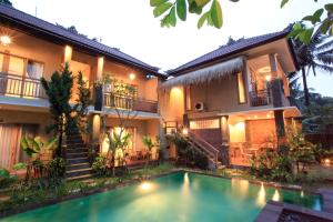 a house with a swimming pool in front of it at Kailash Bali in Ubud