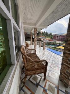a balcony with a chair and a view of a pool at Shivaay Inn in Lava