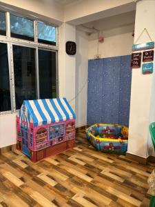 a childs play room with a toy track and a bed at Shivaay Inn in Lava