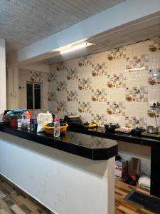 a kitchen with a counter top with dishes on the wall at Shivaay Inn in Lava