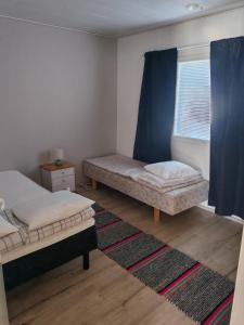 a bedroom with two beds and a window at Pikkurinki 28 As 2, 62300 Härmä Kauhava in Alahärmä