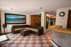 a living room with a couch and a table at Hotel Terranova SM in Santa Marta