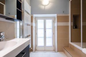 a bathroom with a sink and a door at Casa Rosa - hidden Garden with lake view in Fiumelatte +29 photos